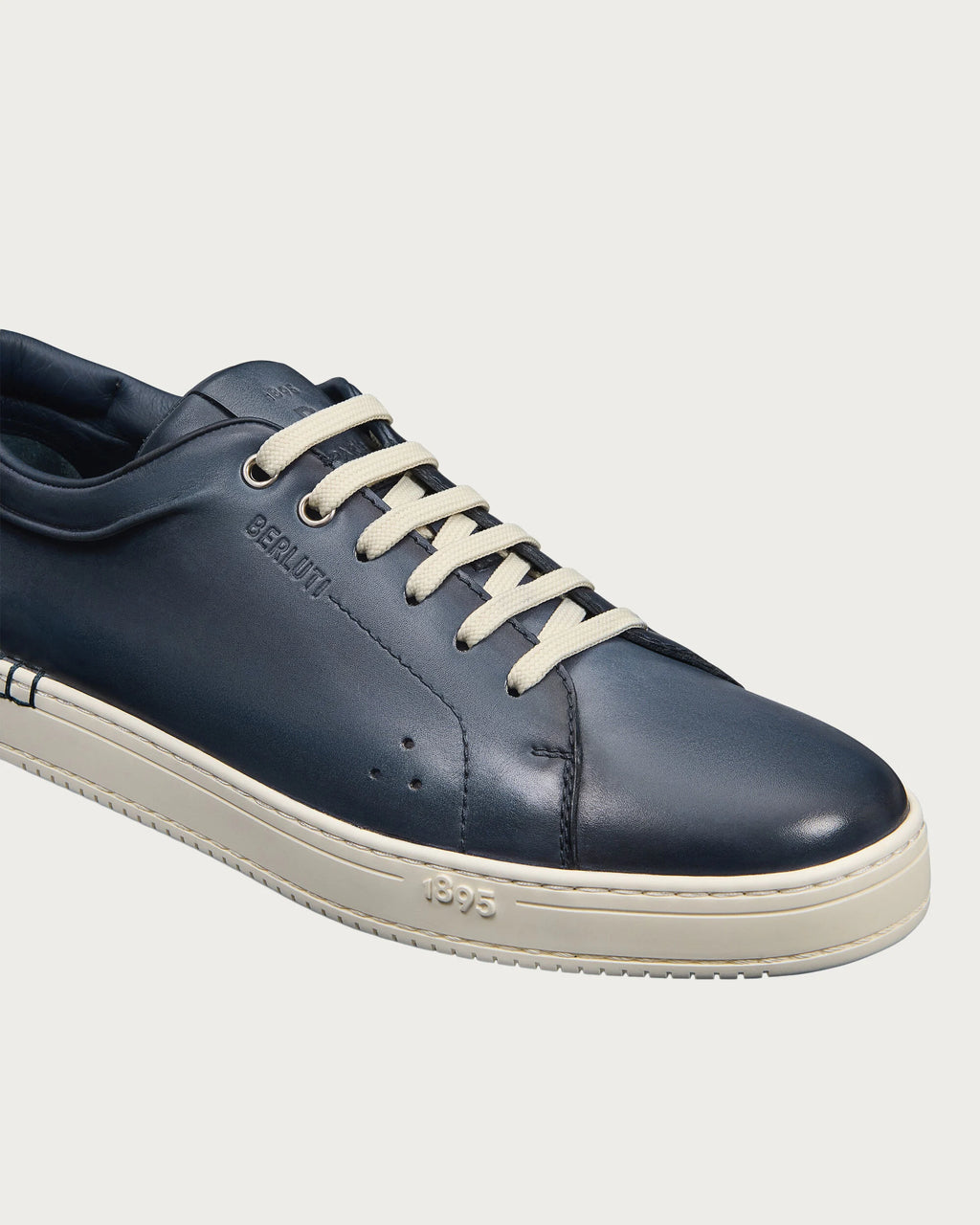 Berluti Playtime sneakers feature navy blue Venezia leather and signature hand