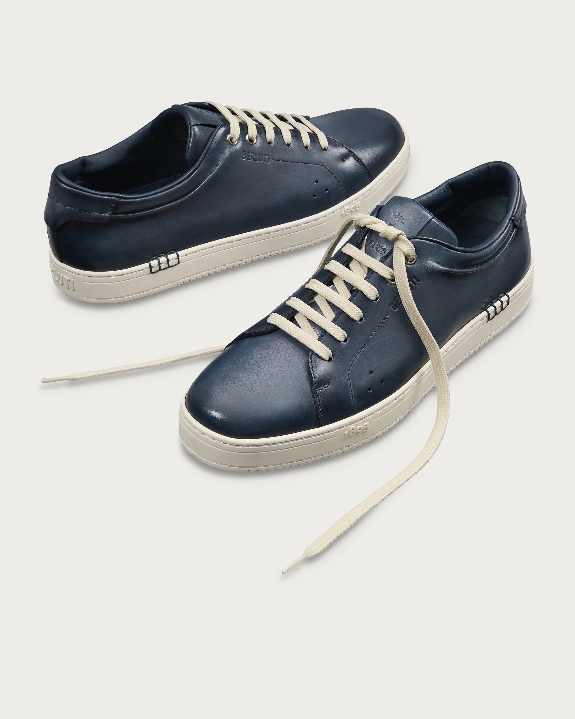 Berluti Playtime sneakers feature navy blue Venezia leather and signature hand